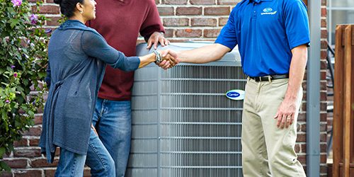 hvac contractor talking with couple