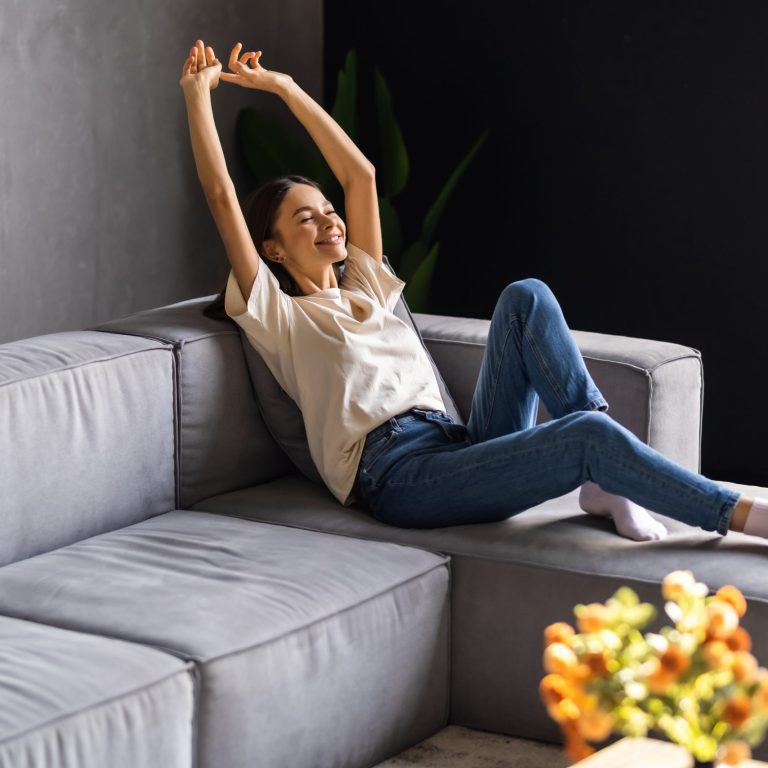 Beautiful woman relaxing lying on a couch at home emergency furnace repair