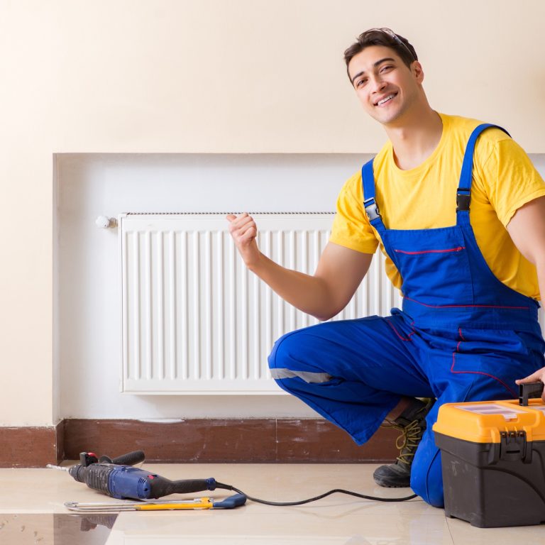 94230626_m_normal_none Young repairman contractor repairing heating panel