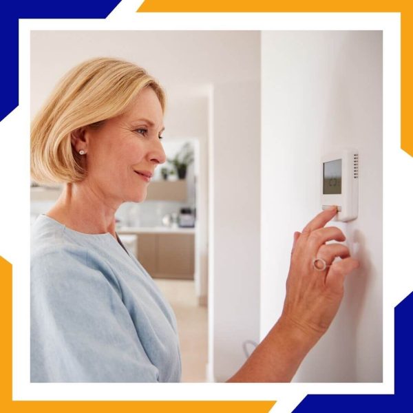 Milliken 3 Woman adjusting thermostat