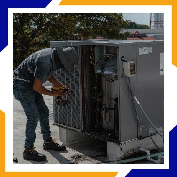 Niwot Location Page - 4 HVAC tech looking at unit on a building's roof