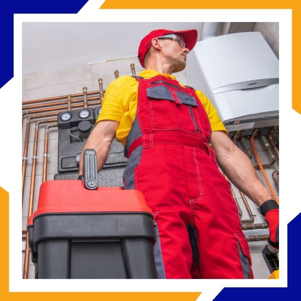 Heating Installation Greeley 3 A technician in red overalls and a red cap arrives with his toolbox to service a boiler system.