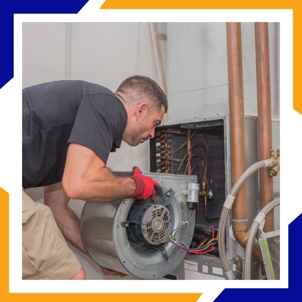 Heating Installation Loveland 2 An HVAC technician installs a blower motor into the furnace of a residential HVAC system.