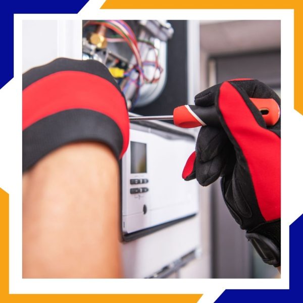 Heating Repair Brighton2 Close-up of a technician's gloved hands using a screwdriver to make a precise adjustment inside a furnace.