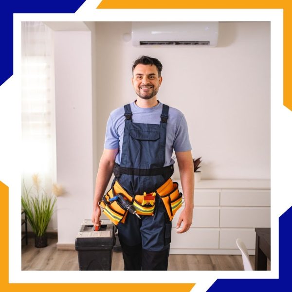A smiling HVAC technician in overalls and a tool belt arrives at a home ready to work.