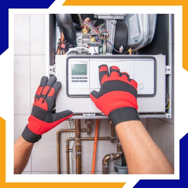 An HVAC technician's gloved hands open the front panel of a modern, wall-mounted heating unit.