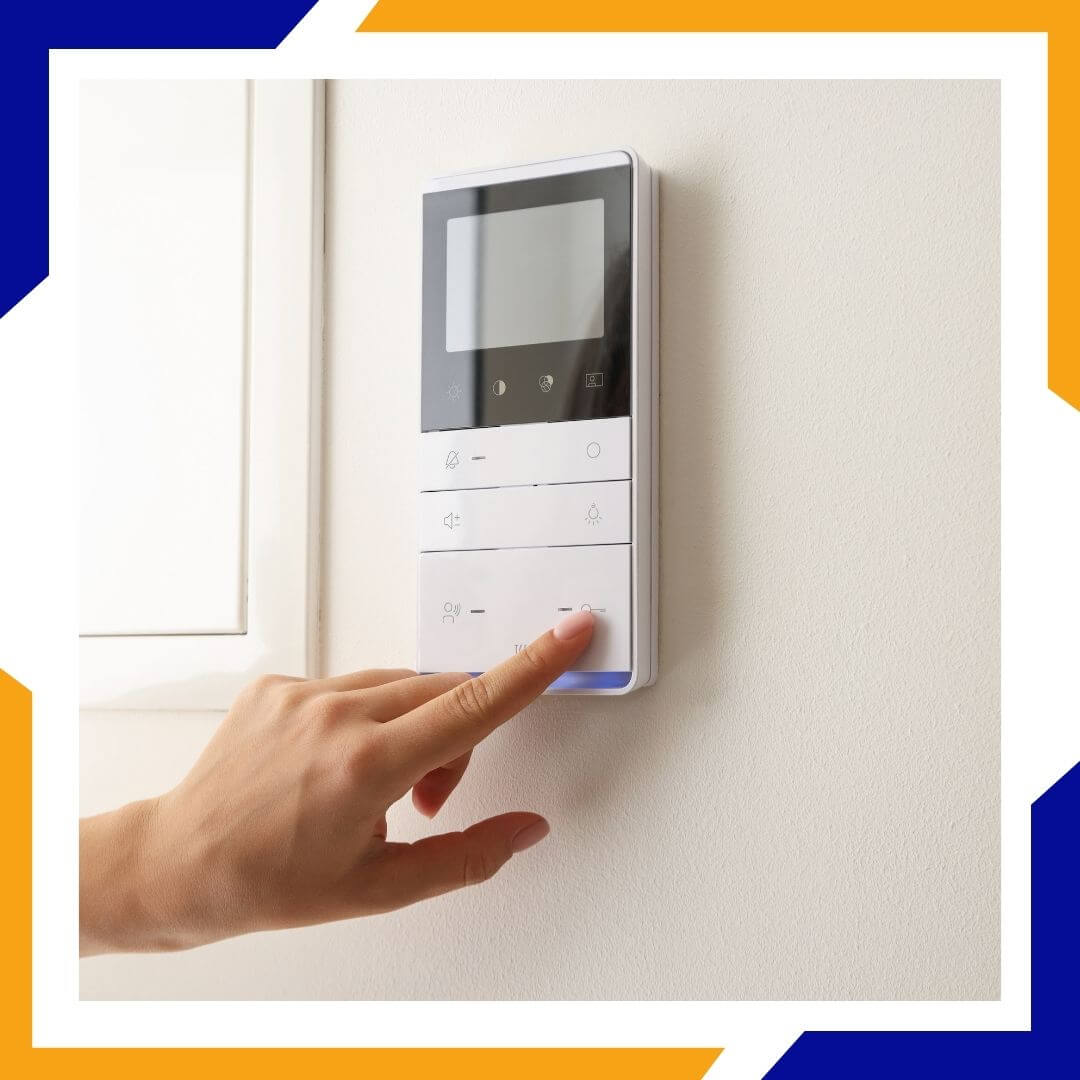 person adjusting a thermostat